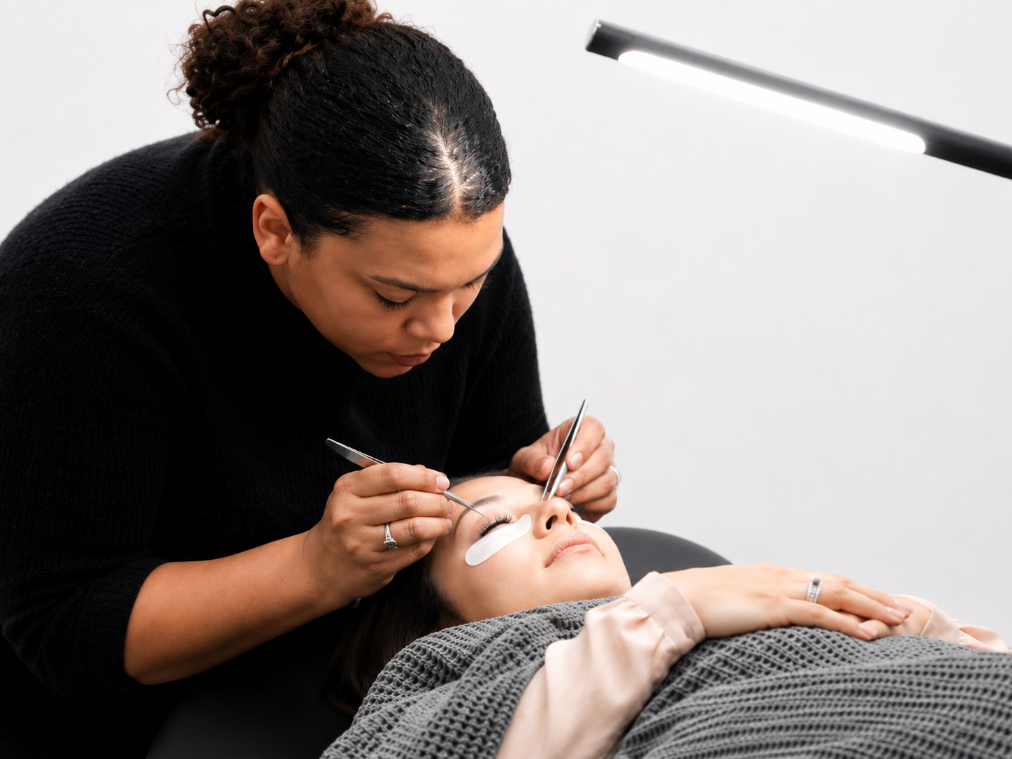 Student performing lash lift service at Wrapture Beauty Academy